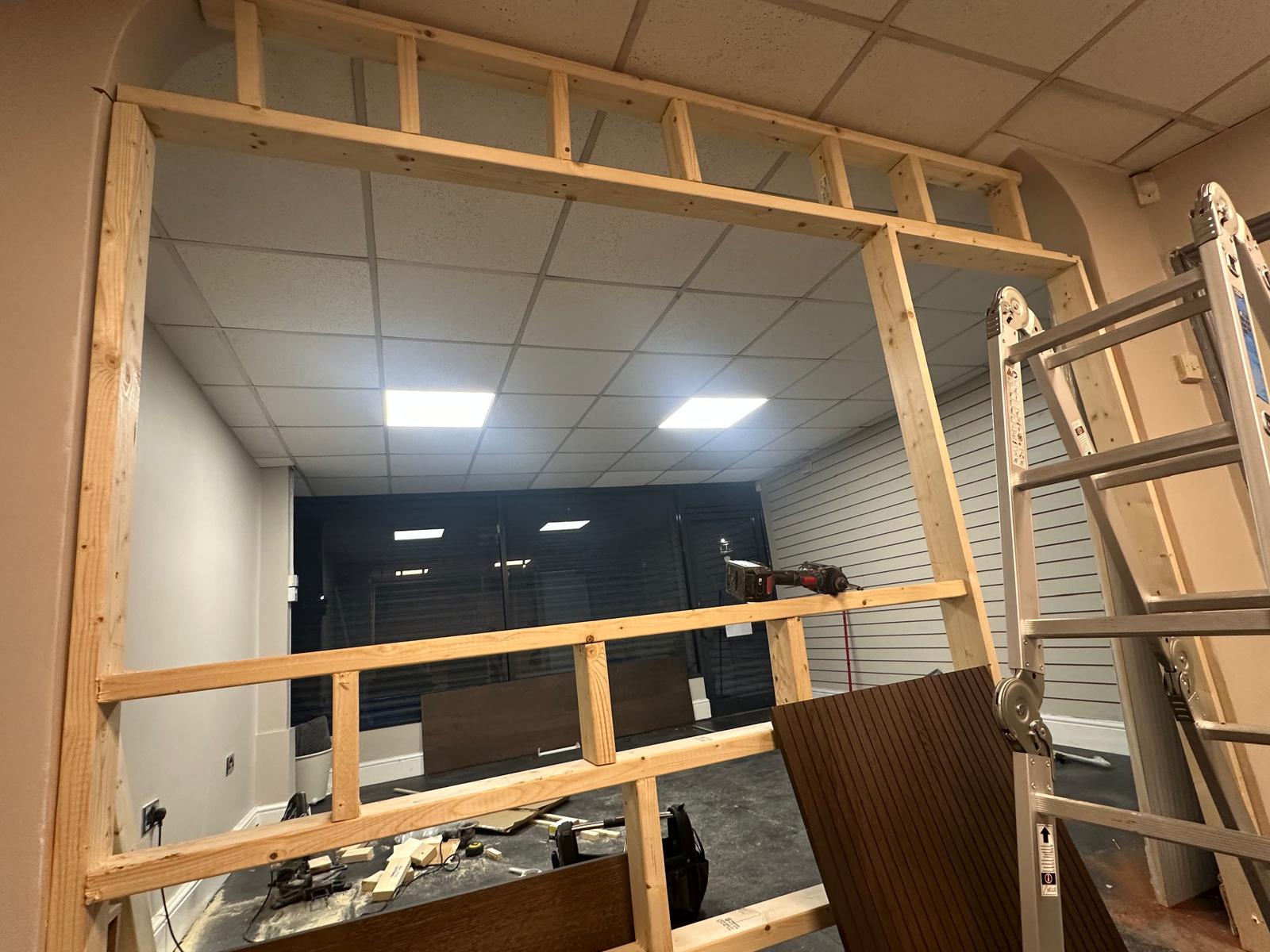 Timber partition wall framing in progress during an interior fit-out job