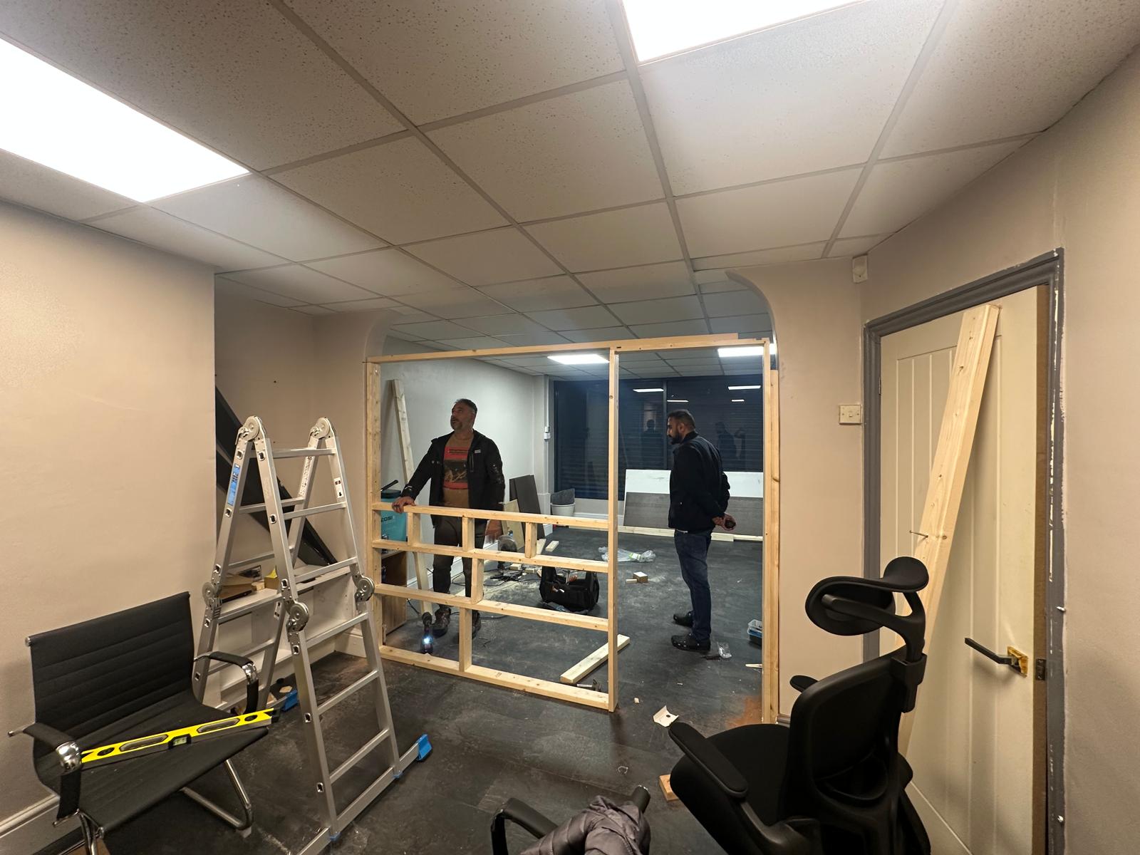 On-site partition framing work being carried out inside a Bolton property